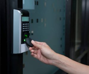 young woman using RFID tag key to open the door